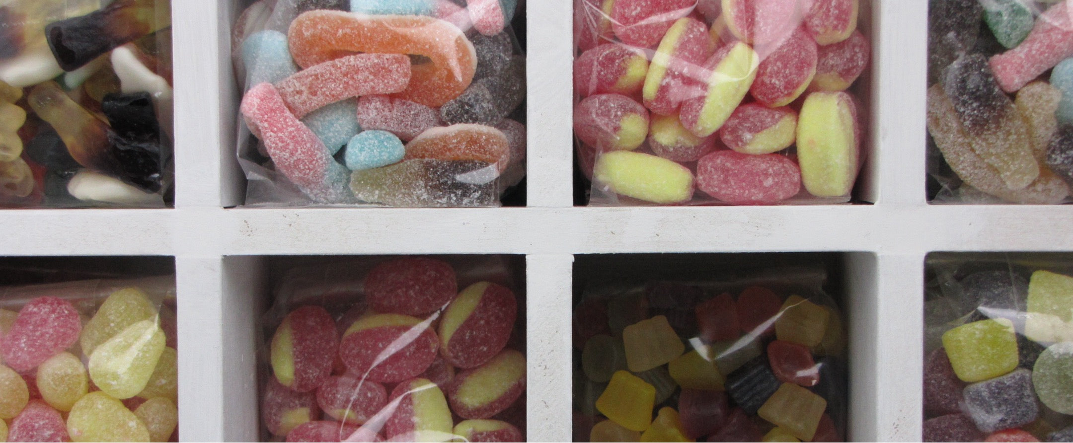 Assorted colorful gummy candies in a grid display.